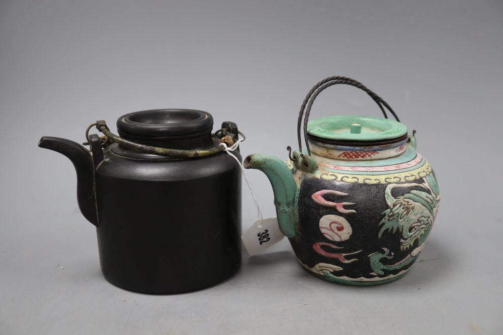 A Chinese enamelled Yixing teapot, height 13cm and a black Yixing teapot